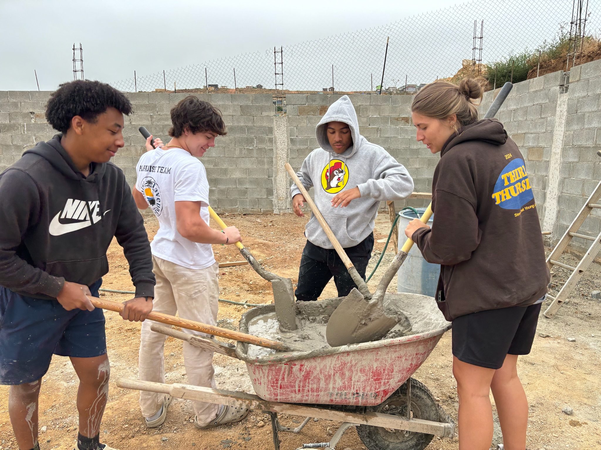 New Hope team members mixing concrete at a home build in Baja, Mexico
